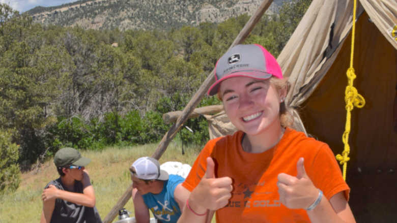 Young people enjoying the outdoors while camping in the mountains.