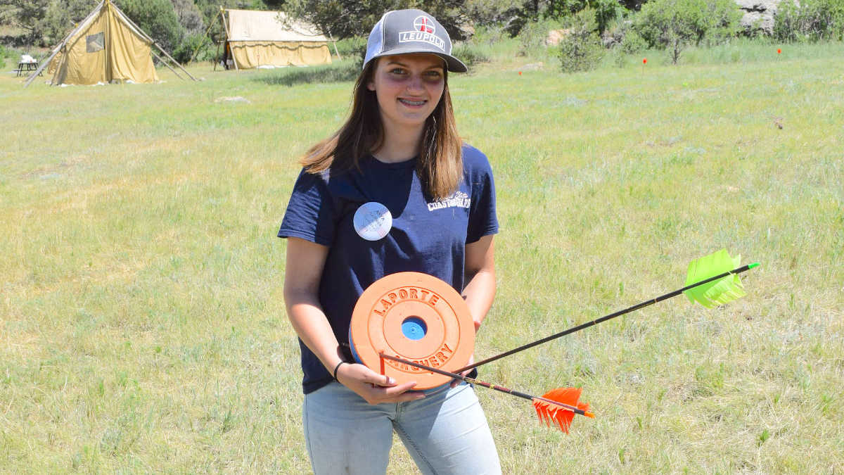 Young woman showing off her archery skills at the NRA Whittington Center Adventure Camp in New Mexico